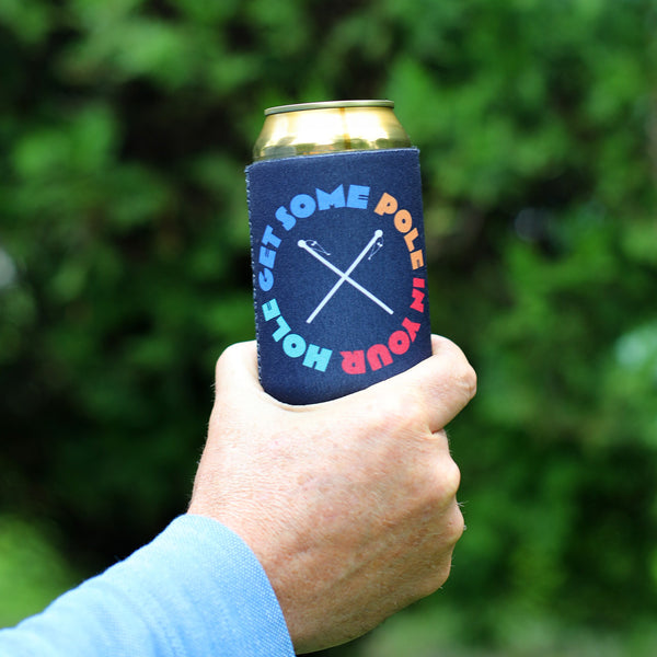 Lifestyle photo of man holding can with coolie that reads "Get Some Pole In Your Hole".